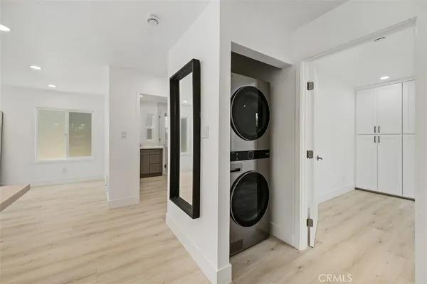 a view of a hallway with washer and dryer