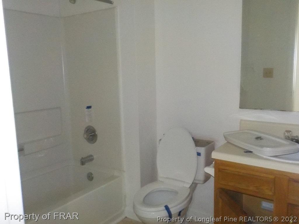 6598 Applewhite Road Fayetteville, NC 28304 - Photo 6 of 9 a bathroom with a sink toilet and shower