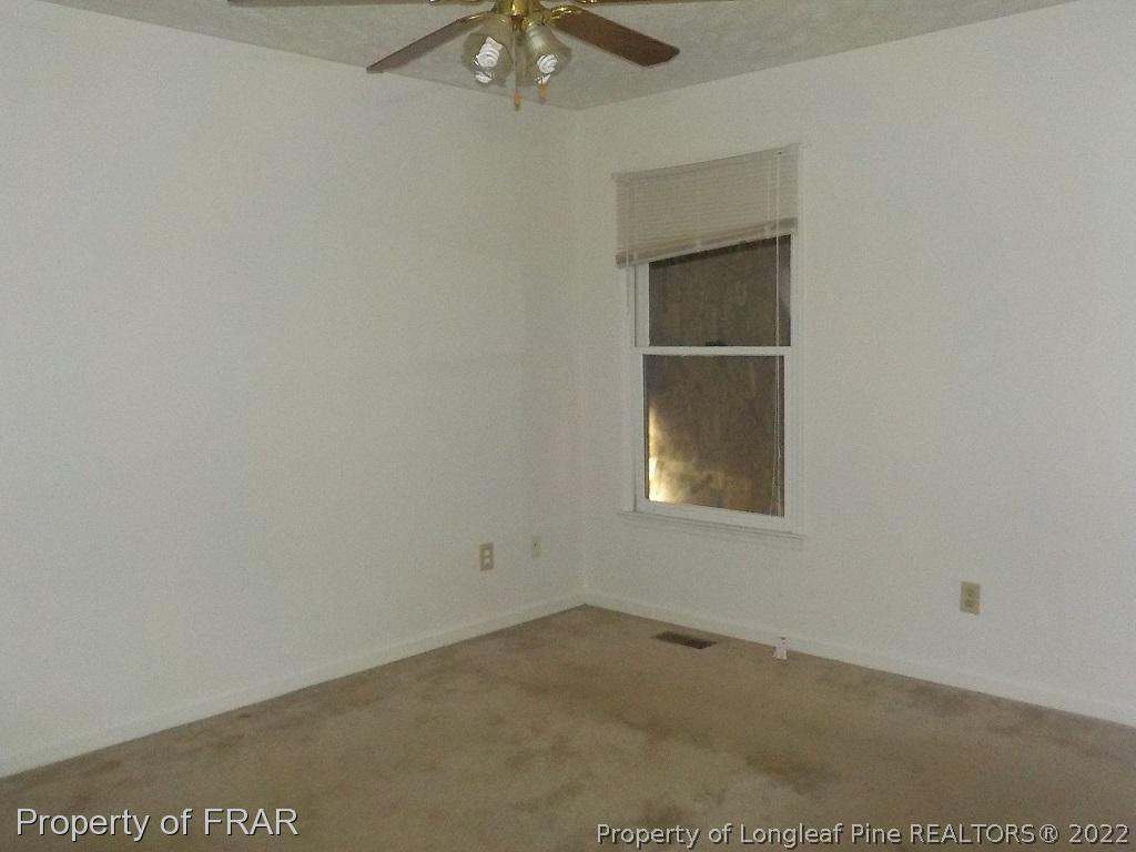 6598 Applewhite Road Fayetteville, NC 28304 - Photo 7 of 9 an empty room with a window
