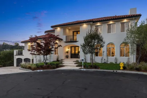 a view of a hallway with entryway and wooden floor