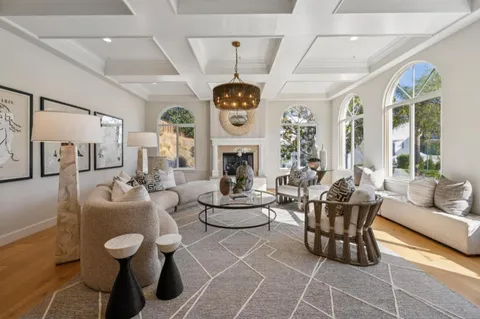 a living room with furniture a table and a fireplace