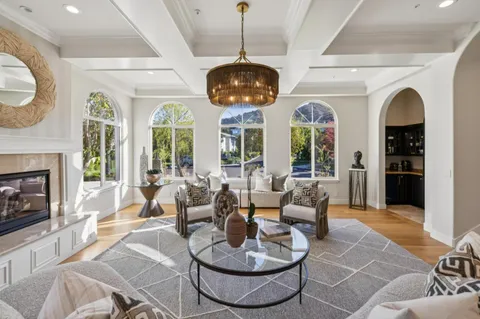 a living room with furniture a rug and white walls