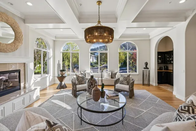 a living room with furniture a rug and white walls
