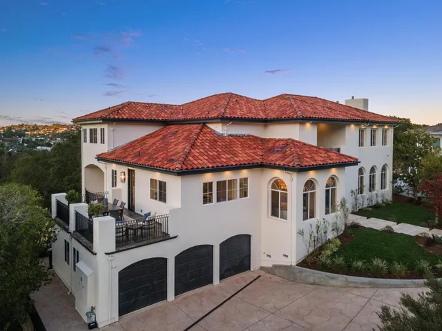 a living room with fireplace furniture and a large window