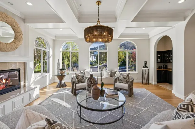 a living room with furniture and a floor to ceiling window