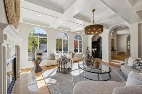 a view of a kitchen with a sink and large window