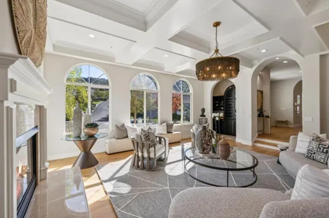 a kitchen with stainless steel appliances granite countertop a stove top oven a sink dishwasher and white cabinets with wooden floor