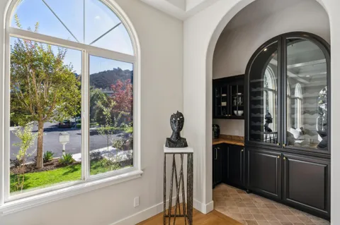 a living room with furniture a fireplace and a large window