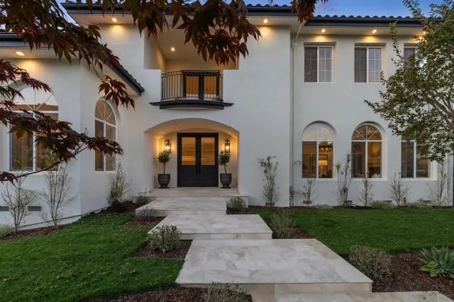 a living room with furniture a fireplace and a floor to ceiling window