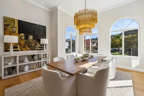 a bedroom with a bed a dresser and potted plants