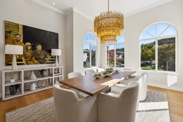 a bedroom with a bed a dresser and potted plants