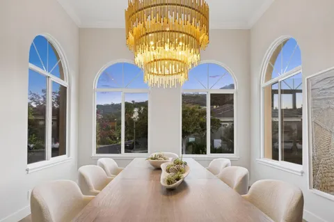 a bedroom with a large bed and a chandelier