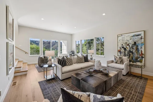 a view of a chairs and table in the balcony