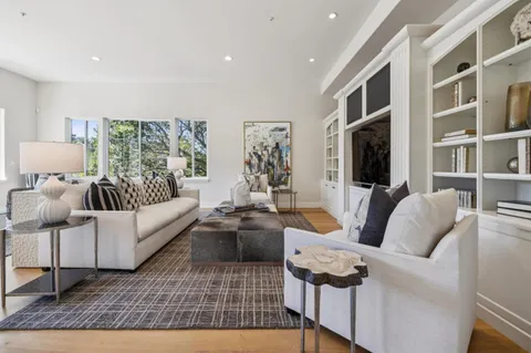 a front view of a house with a garden and plants