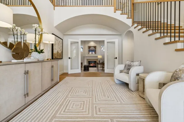 a living room with furniture a dining table and a chandelier