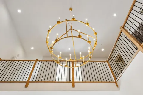 a living room with fireplace furniture and a large window