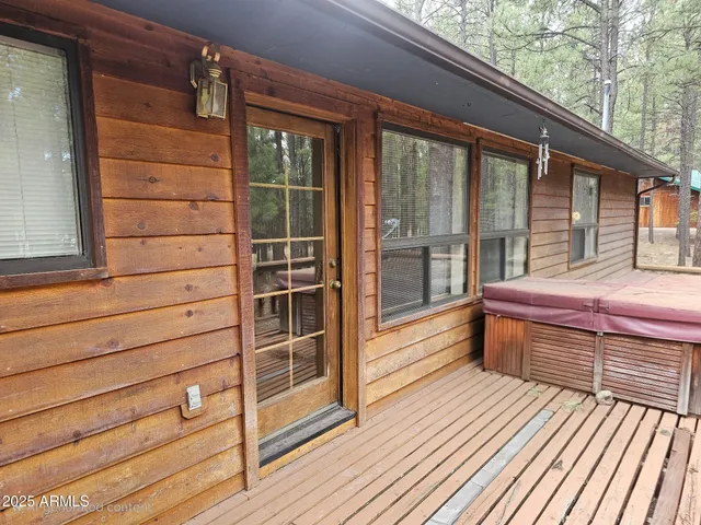 a view of a balcony with door and wooden floor