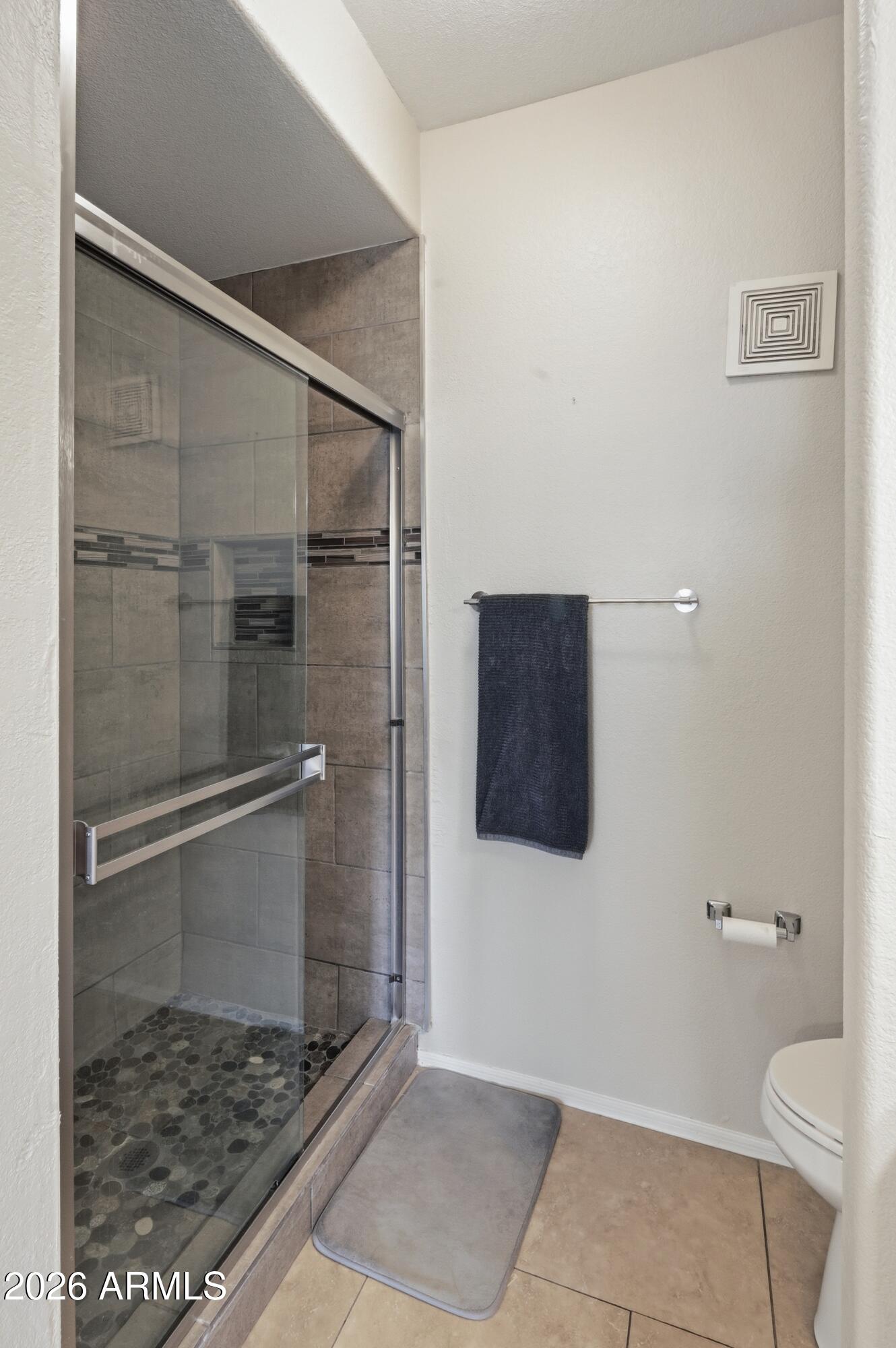 5303 North 7th Street, Unit 220 Phoenix, AZ 85014 - Photo 19 of 33 a bathroom with a granite countertop toilet and a shower