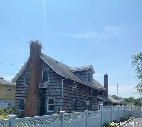 a view of a house with wooden fence