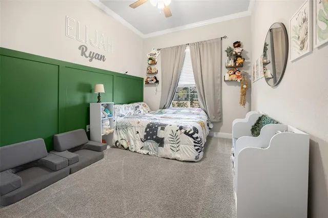 a bedroom with furniture and a large window