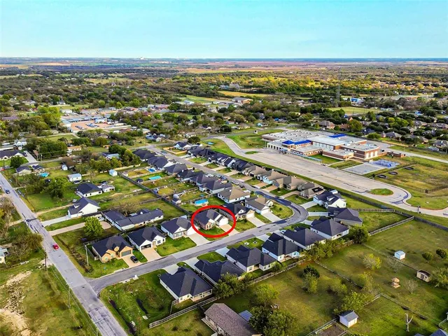 an aerial view of residential houses with outdoor space