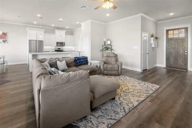 a living room with furniture and kitchen view