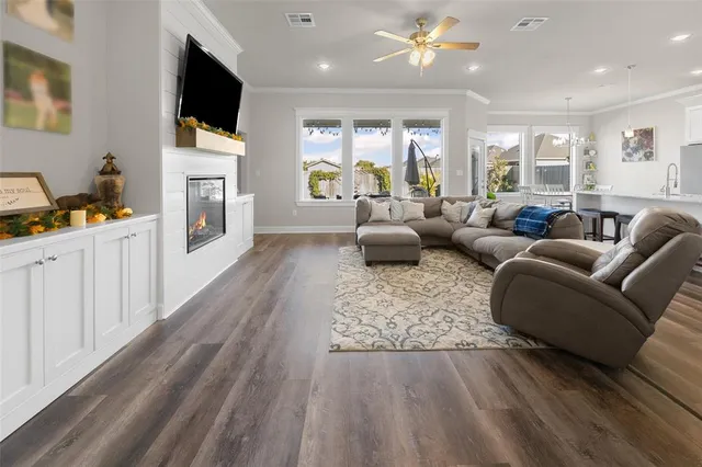 a living room with fireplace furniture and a flat screen tv