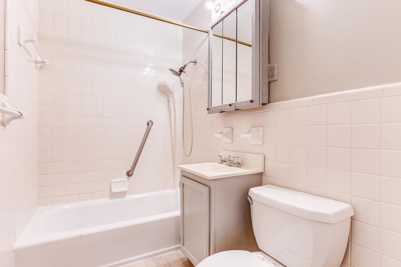 1369 Marcia Road Memphis, TN 38117 - Photo 14 of 25 a bath room with a toilet a sink and a bath tub