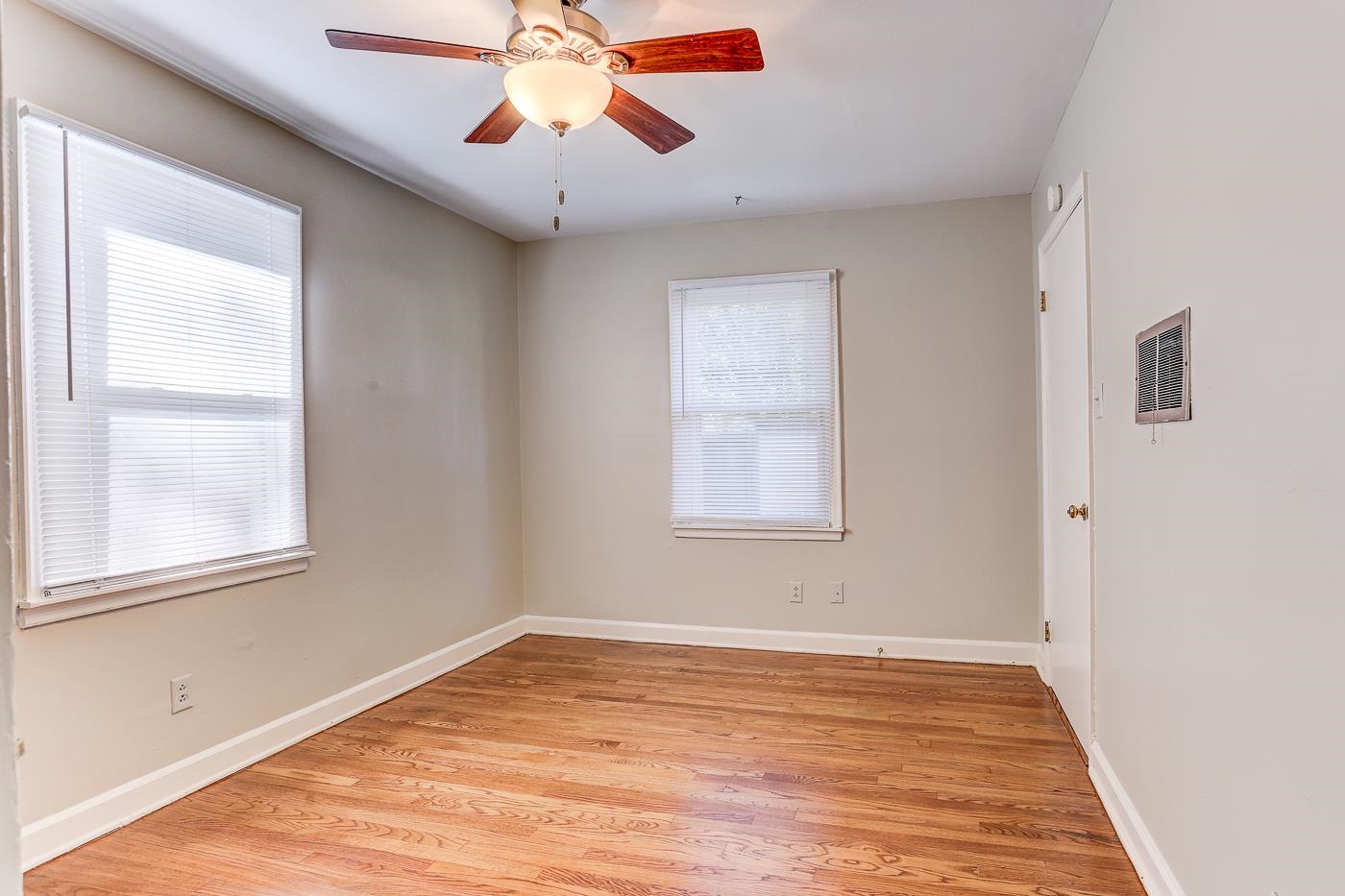 1369 Marcia Road Memphis, TN 38117 - Photo 15 of 25 a view of an empty room with wooden floor and a window