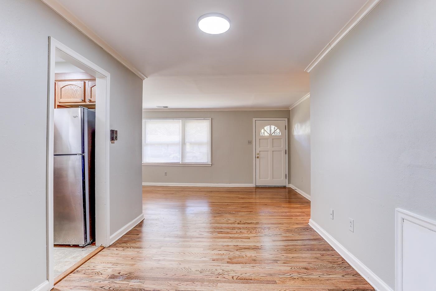 1369 Marcia Road Memphis, TN 38117 - Photo 17 of 25 a view of an empty room with window and wooden floor