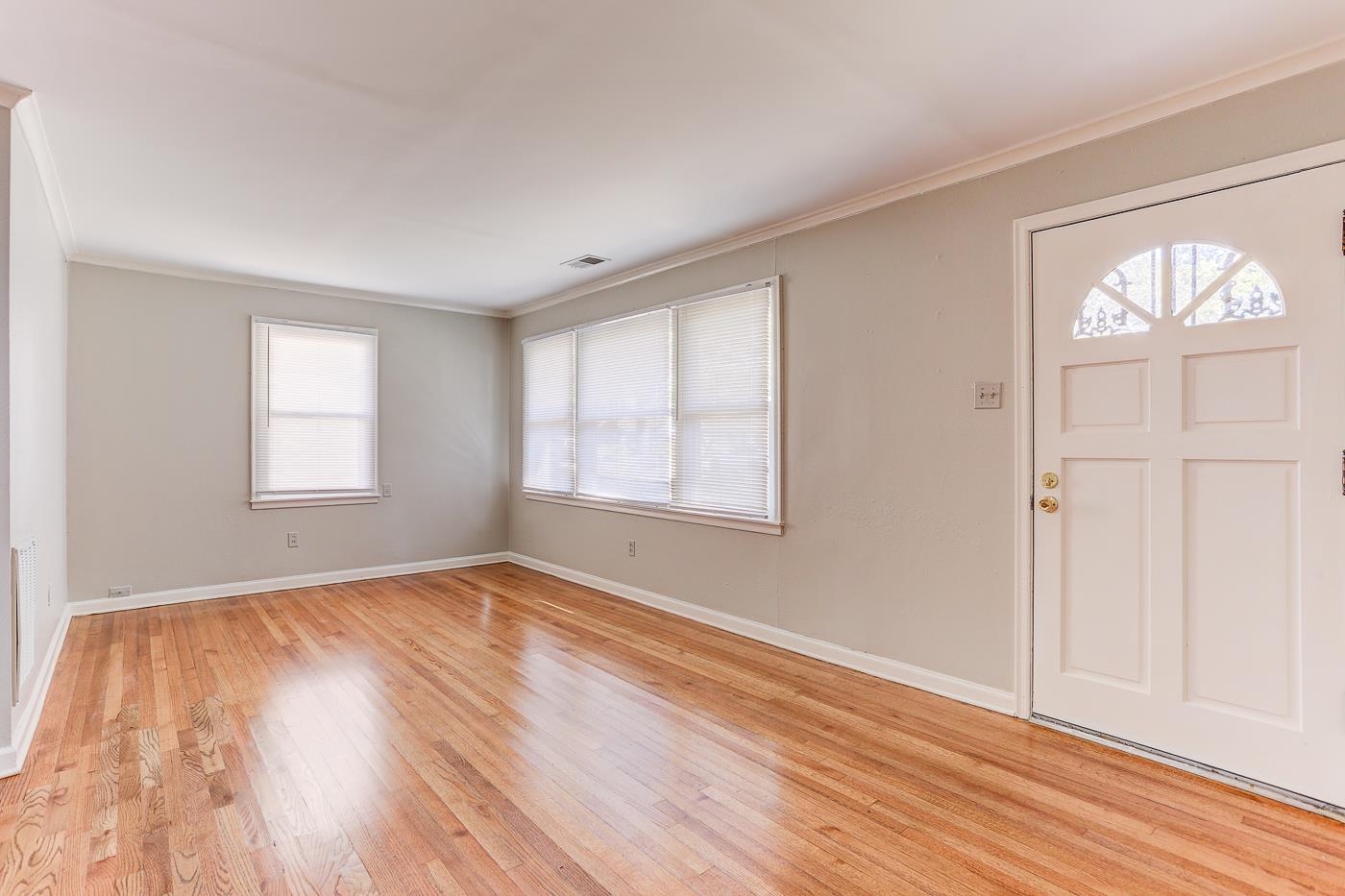 1369 Marcia Road Memphis, TN 38117 - Photo 24 of 25 a view of an empty room with wooden floor and a window
