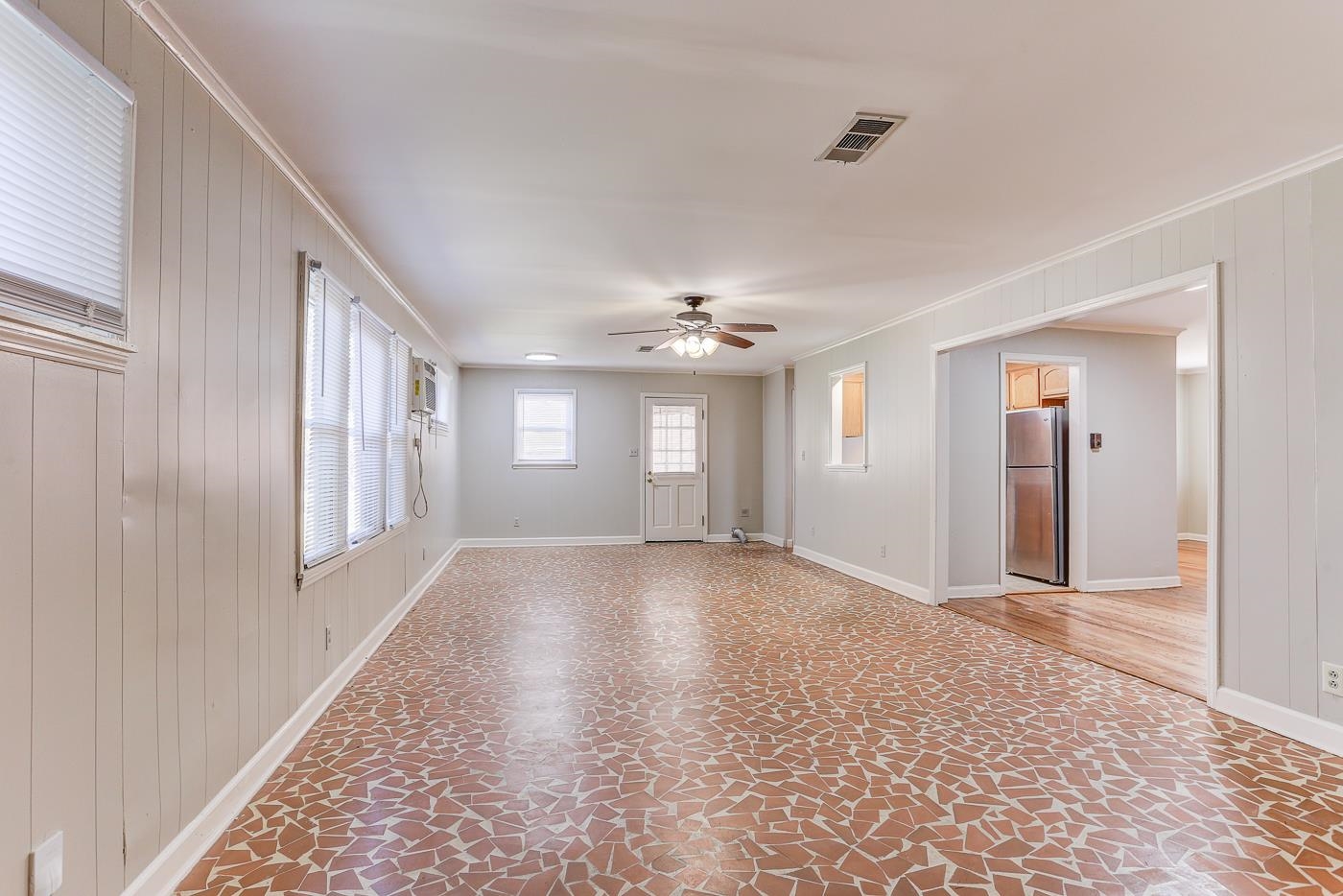 1369 Marcia Road Memphis, TN 38117 - Photo 5 of 25 a view of an empty room with window and wooden floor