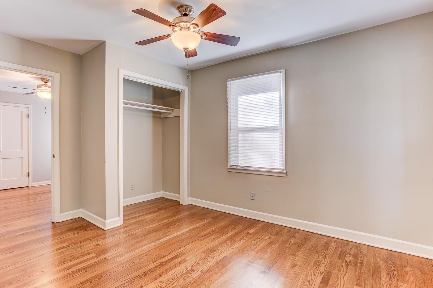 1369 Marcia Road Memphis, TN 38117 - Photo 10 of 25 a view of an empty room with wooden floor and a window