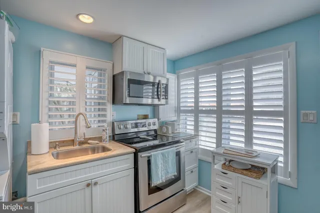 a kitchen with stainless steel appliances a stove microwave and refrigerator