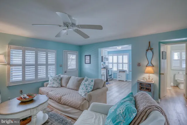 a living room with furniture and a view of kitchen