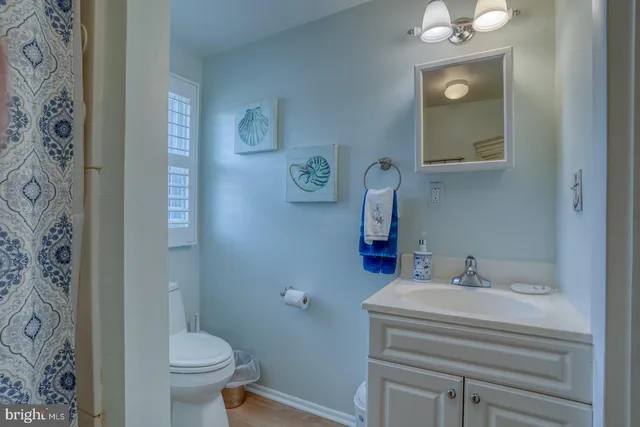 a view of a house with a barbeque and large trees
