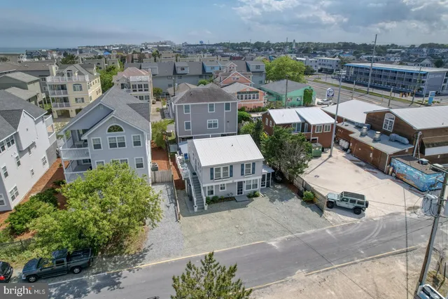 an aerial view of a house with a yard and lake view