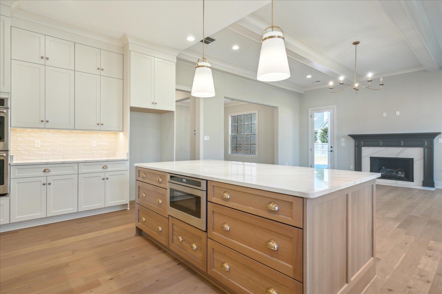 12620 Miss Cloud Road Collierville, TN 38017 - Photo 13 of 38 Kitchen featuring a kitchen island, white cabinets, and pendant lighting