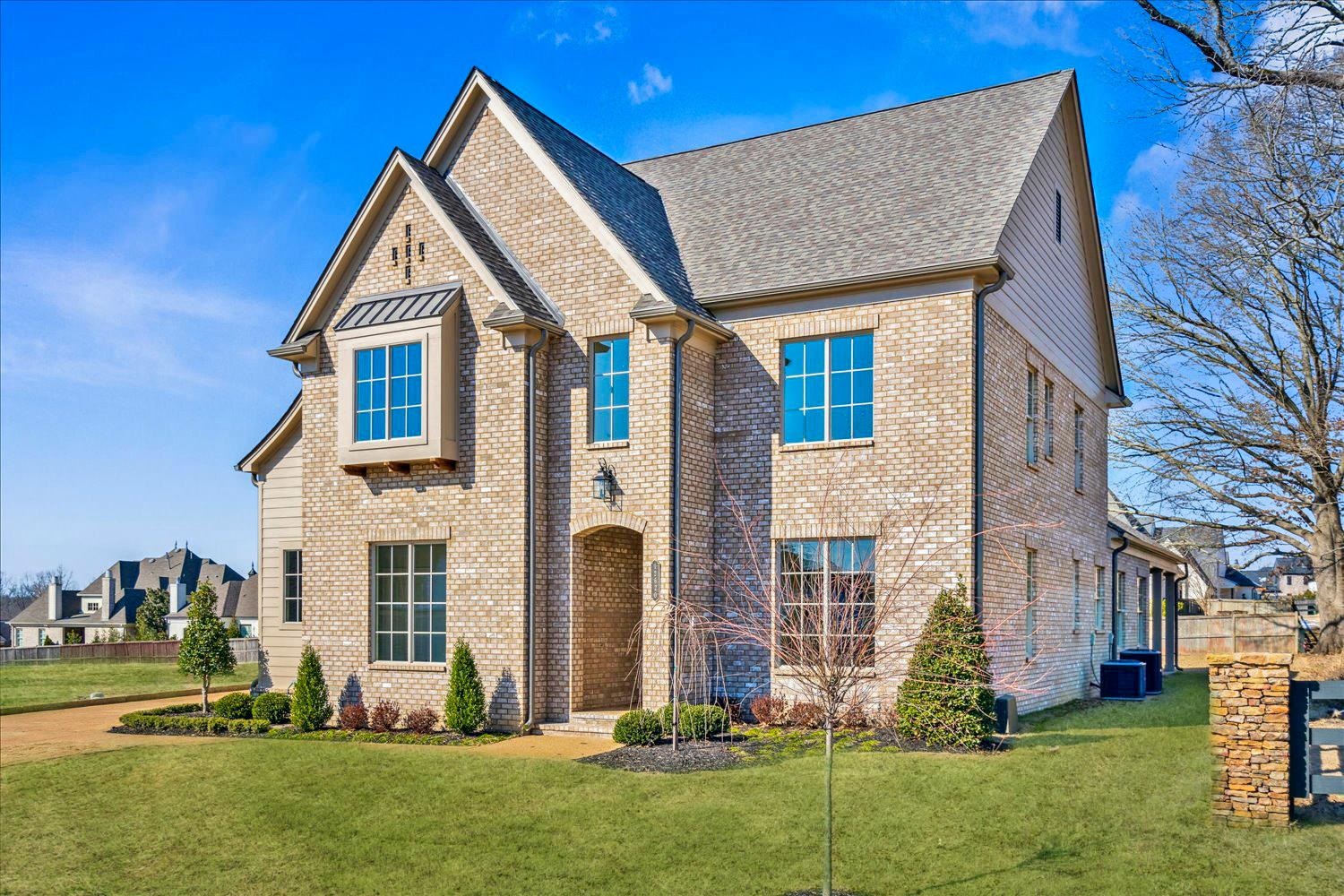 12620 Miss Cloud Road Collierville, TN 38017 - Photo 2 of 38 View of front facade featuring a front yard, brick siding, and roof with shingles
