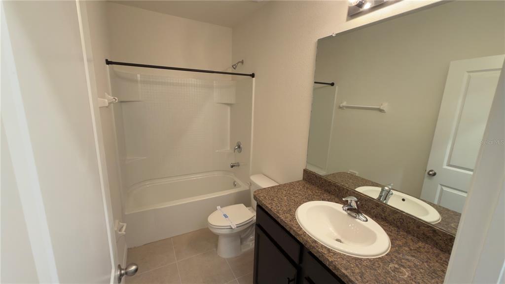 1881 Hovenweep Road Wesley Chapel, FL 33543 - Photo 18 of 18 a bathroom with a granite countertop sink toilet and shower