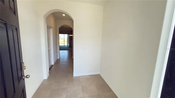 a kitchen with granite countertop a refrigerator a stove and wooden cabinets