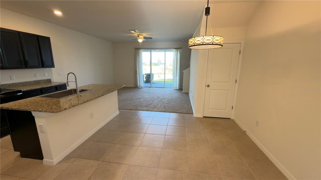 1881 Hovenweep Road Wesley Chapel, FL 33543 - Photo 6 of 18 a kitchen with a sink a counter top space and cabinets