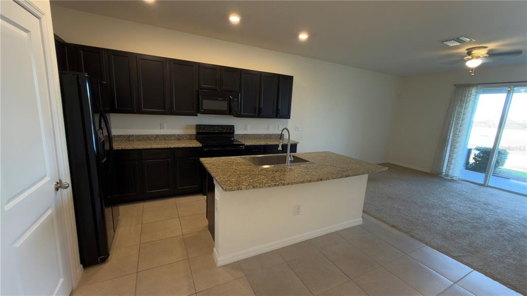 1881 Hovenweep Road Wesley Chapel, FL 33543 - Photo 7 of 18 a kitchen with a sink and cabinets