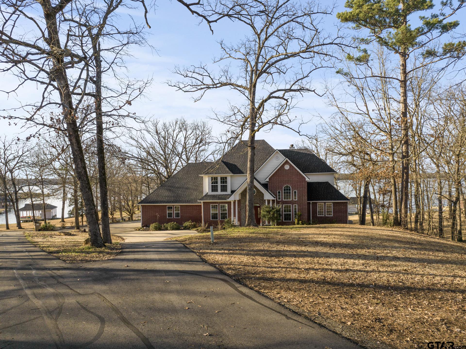 59 Private Road Pittsburg, TX 75686 - Photo 1 of 45 a front view of a building with trees
