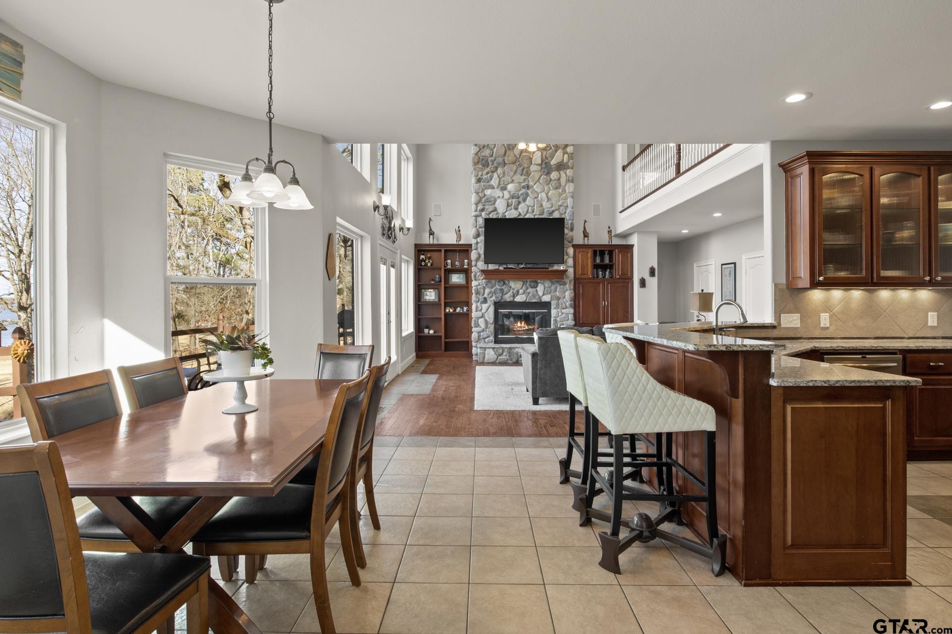 59 Private Road Pittsburg, TX 75686 - Photo 12 of 45 a dining hall with stainless steel appliances kitchen island granite countertop a dining table chairs and granite counter tops