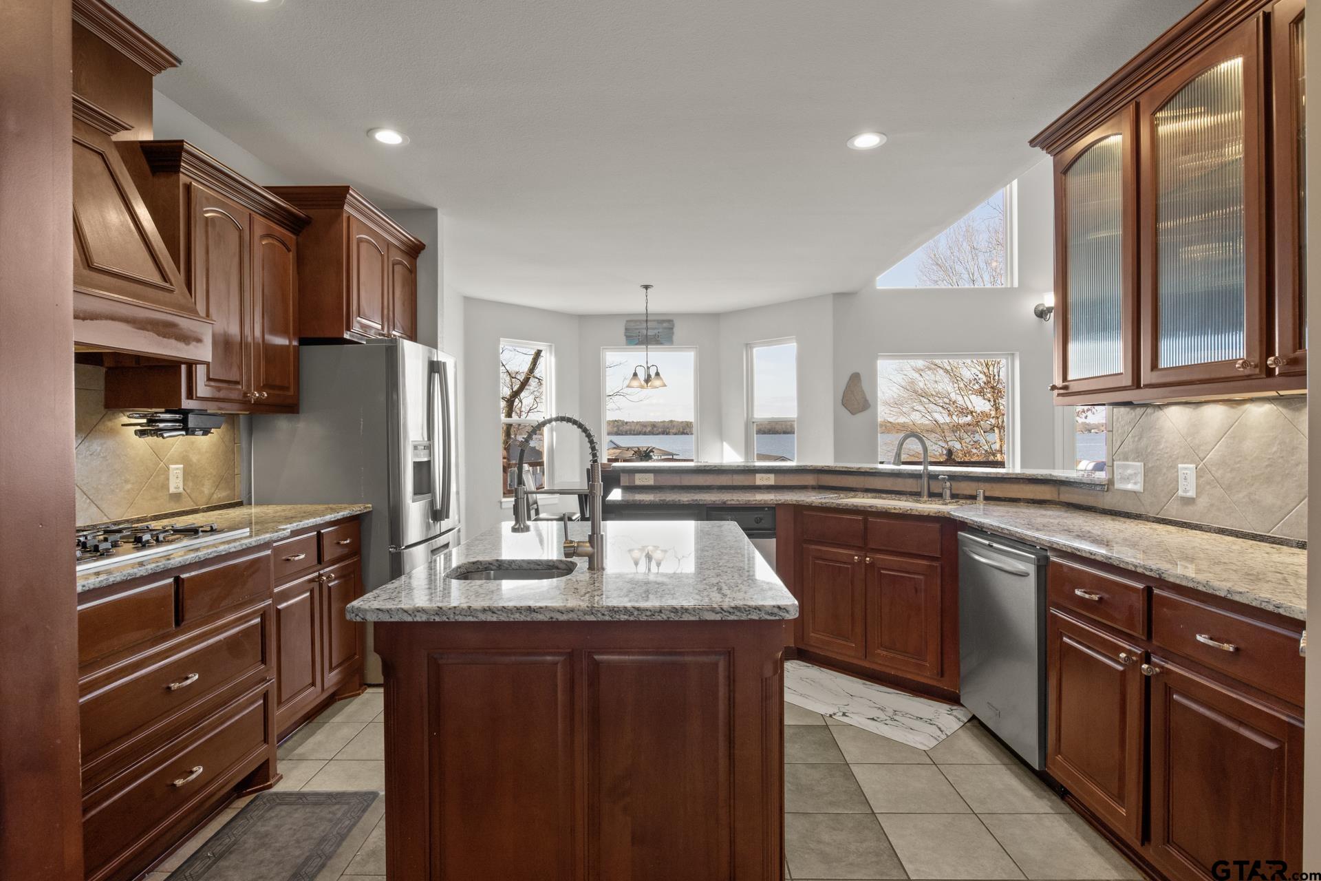 59 Private Road Pittsburg, TX 75686 - Photo 16 of 45 a kitchen with stainless steel appliances granite countertop a sink stove and refrigerator