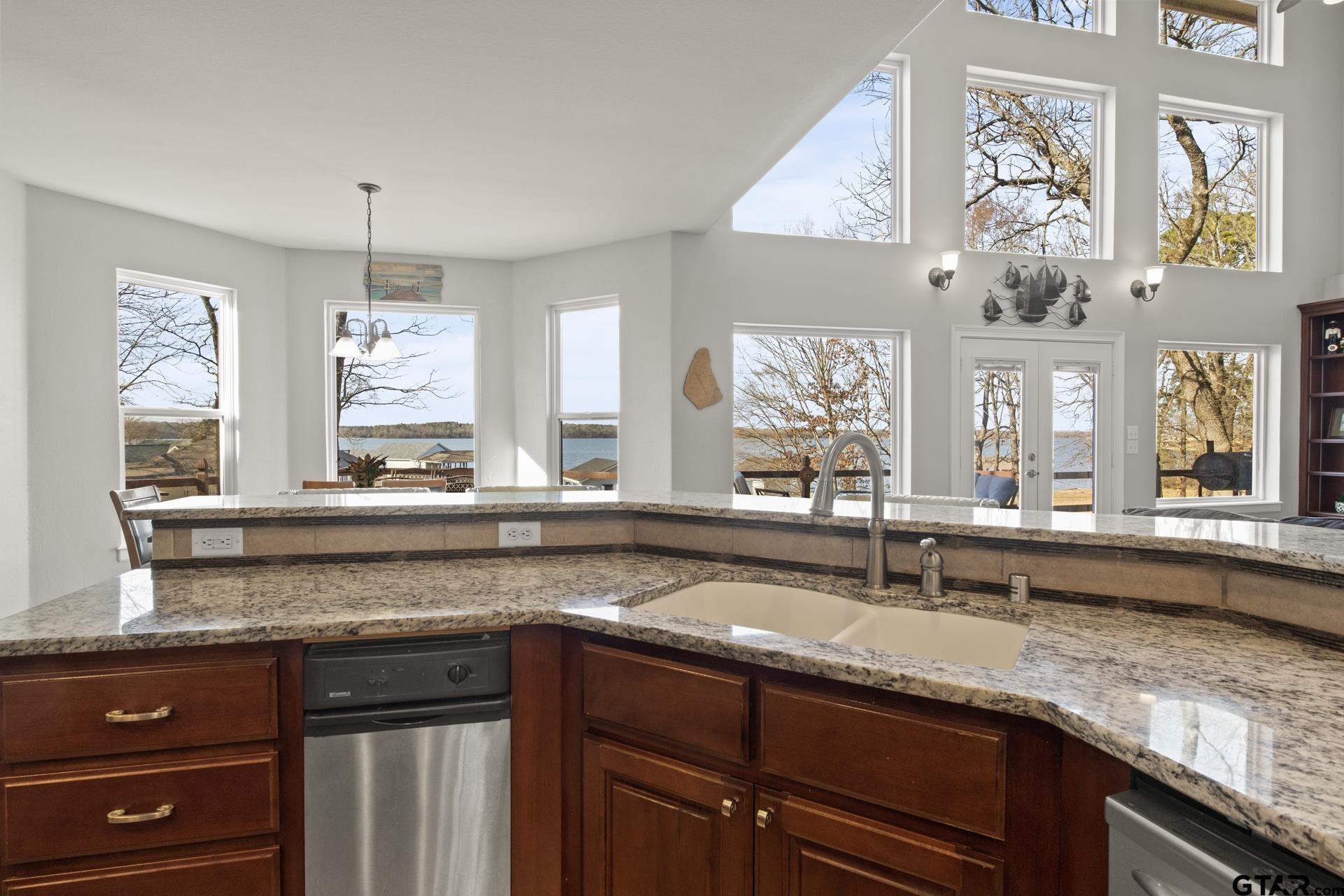 59 Private Road Pittsburg, TX 75686 - Photo 18 of 45 a kitchen with granite countertop cabinets a sink and dishwasher