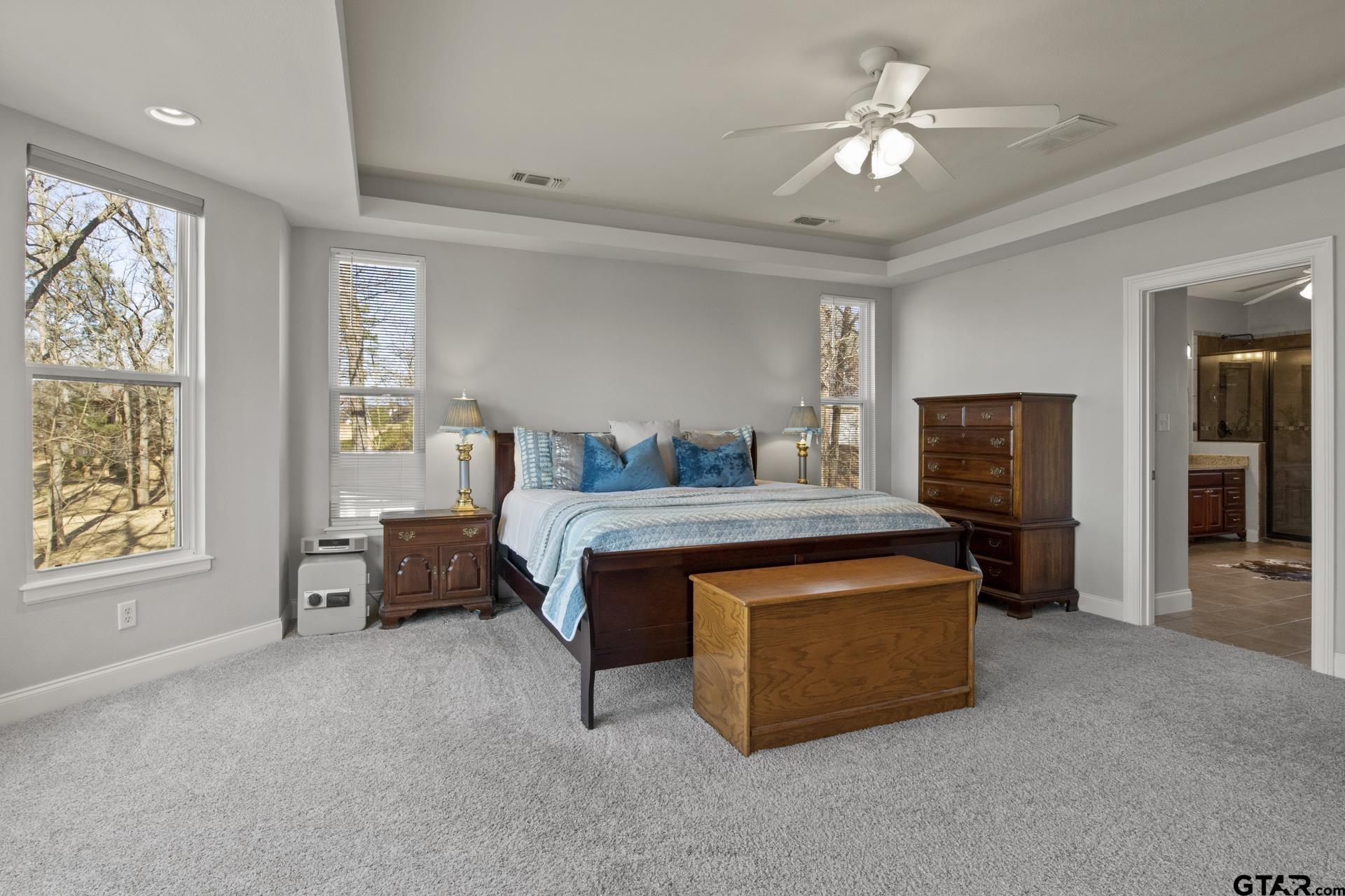 59 Private Road Pittsburg, TX 75686 - Photo 21 of 45 a bedroom with a bed and a chandelier