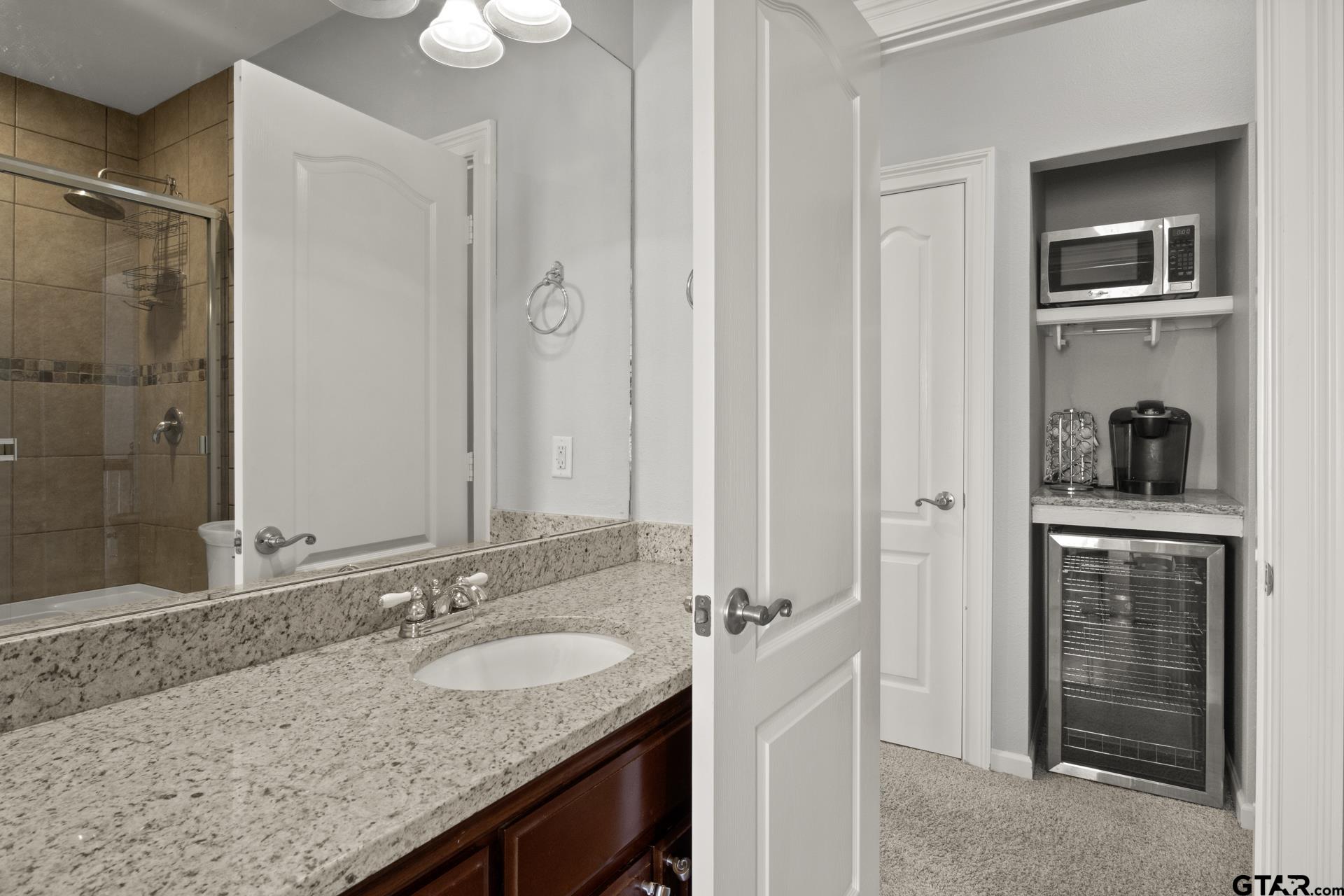 59 Private Road Pittsburg, TX 75686 - Photo 29 of 45 a bathroom with a granite countertop sink and a mirror