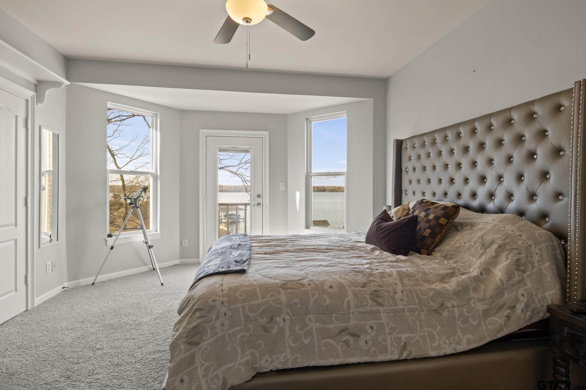 59 Private Road Pittsburg, TX 75686 - Photo 30 of 45 a large bed sitting in a bedroom next to a window